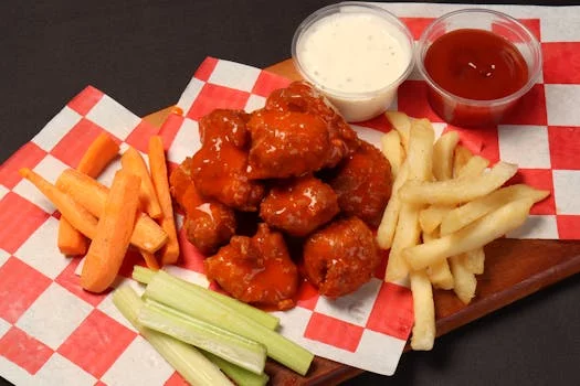crispy buffalo wings with celery sticks